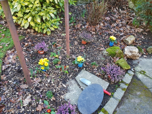 Planting spring flowers by the entrance