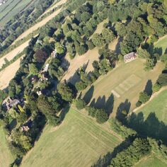 Views from a microlite - The cricket pitch, All Saints Church and Court Lodge Farm to the left side.